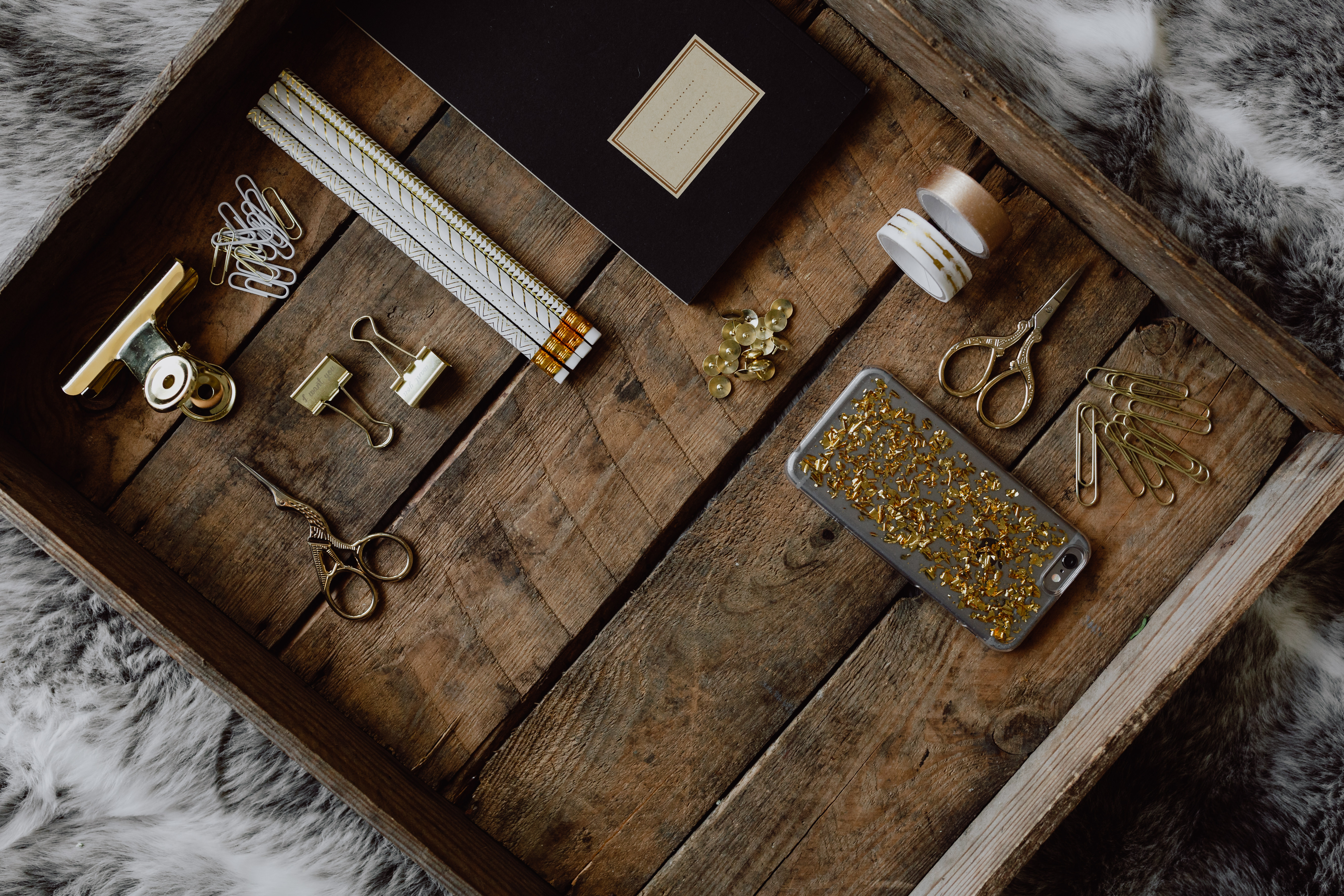 Office accessories on an old wooden tray