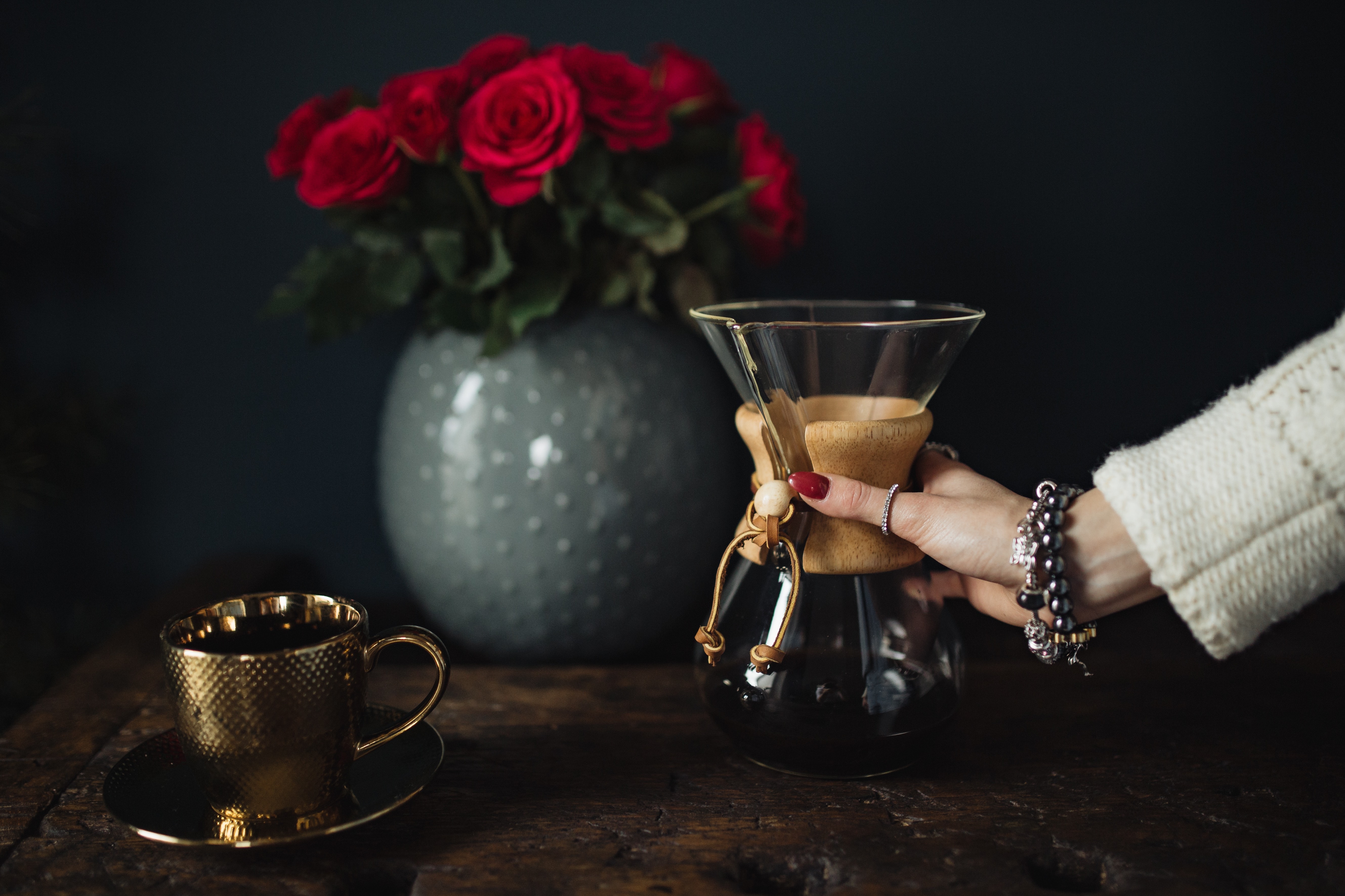 Enjoying a finely brewed coffee, gold coffee cup & red roses