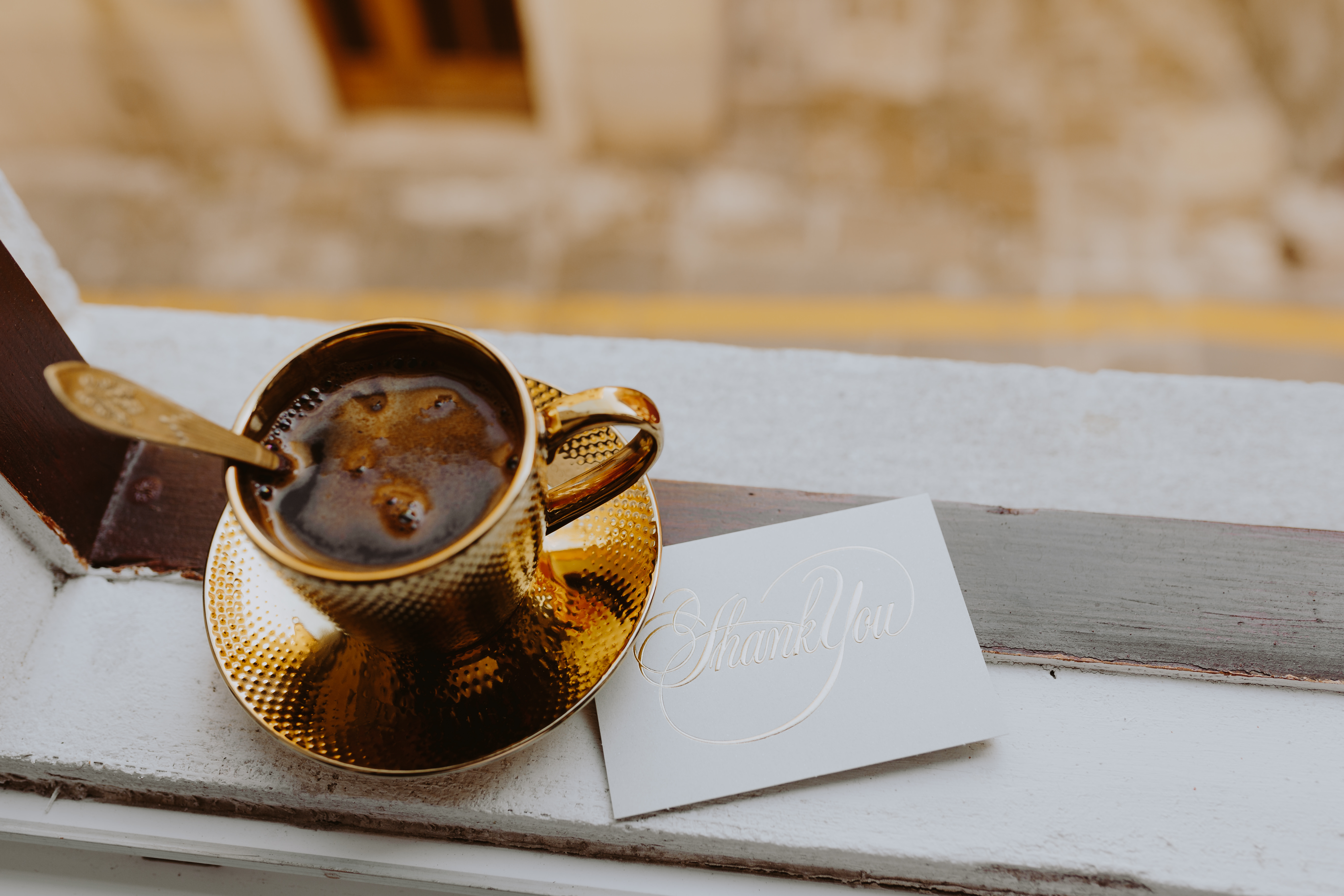 Drink coffee in a golden cup at the window