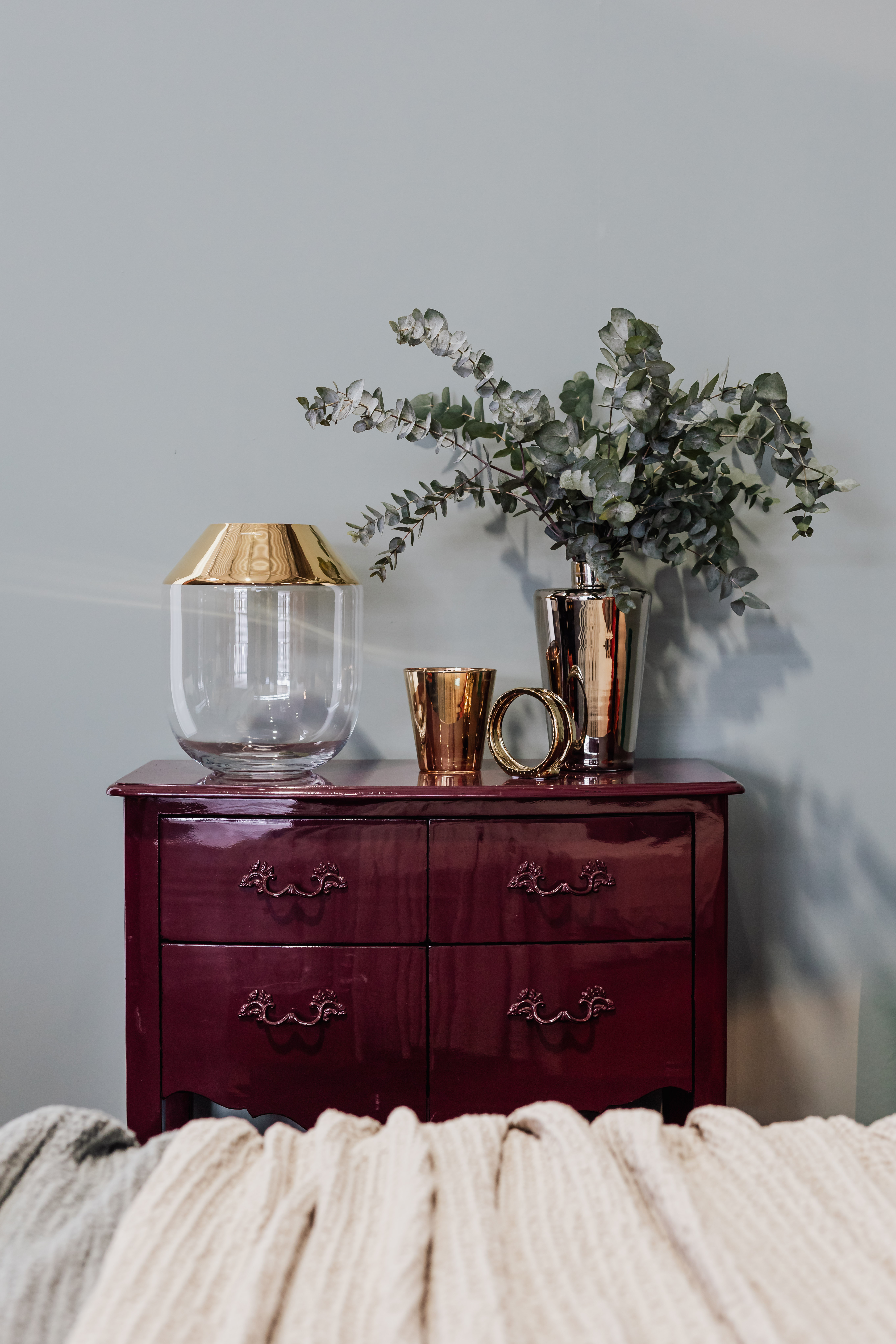 Cabinet with gold decorations and eucalyptus