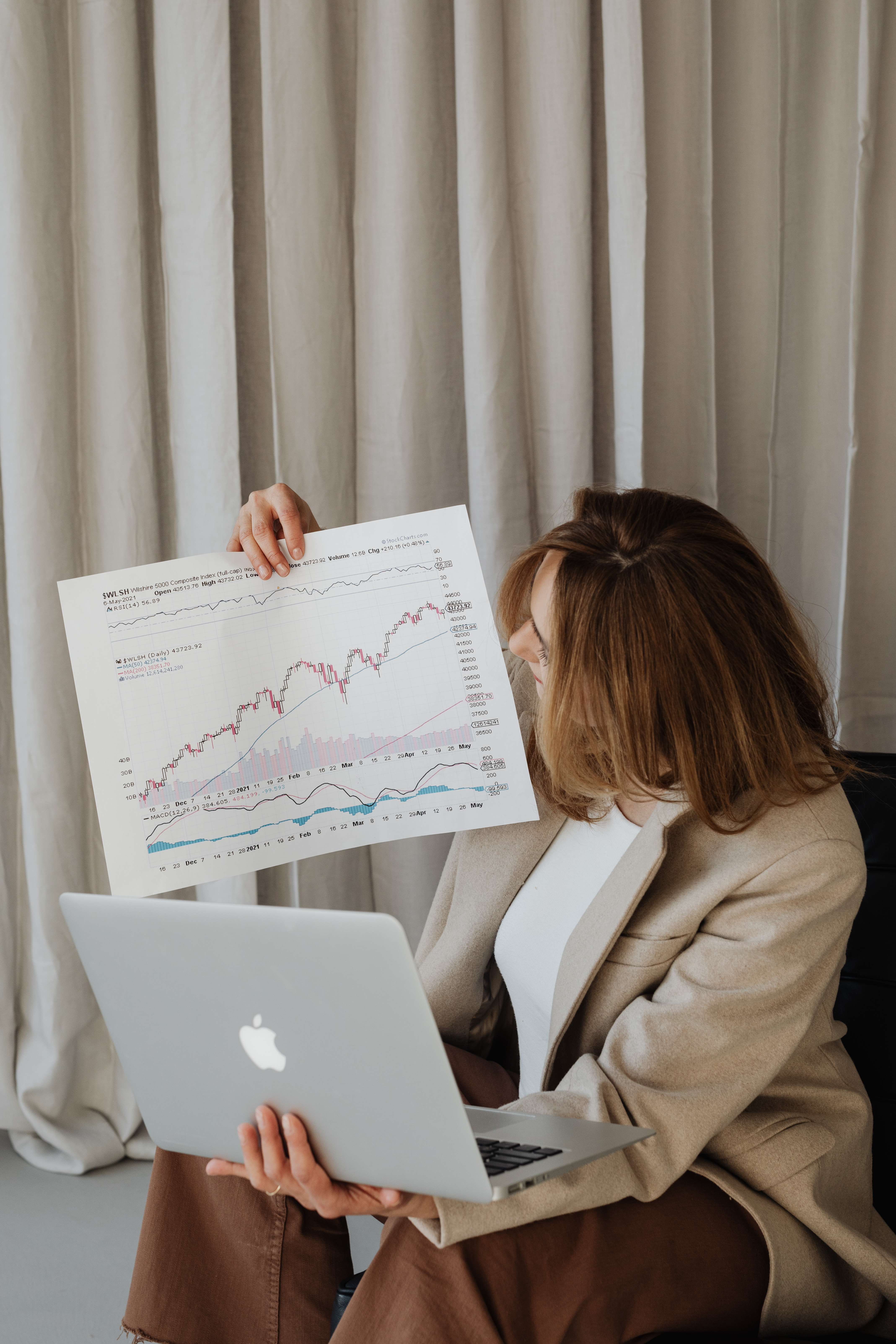 Businesswoman studies charts - currency exchange rate - stock market - bitcoin exchange rate