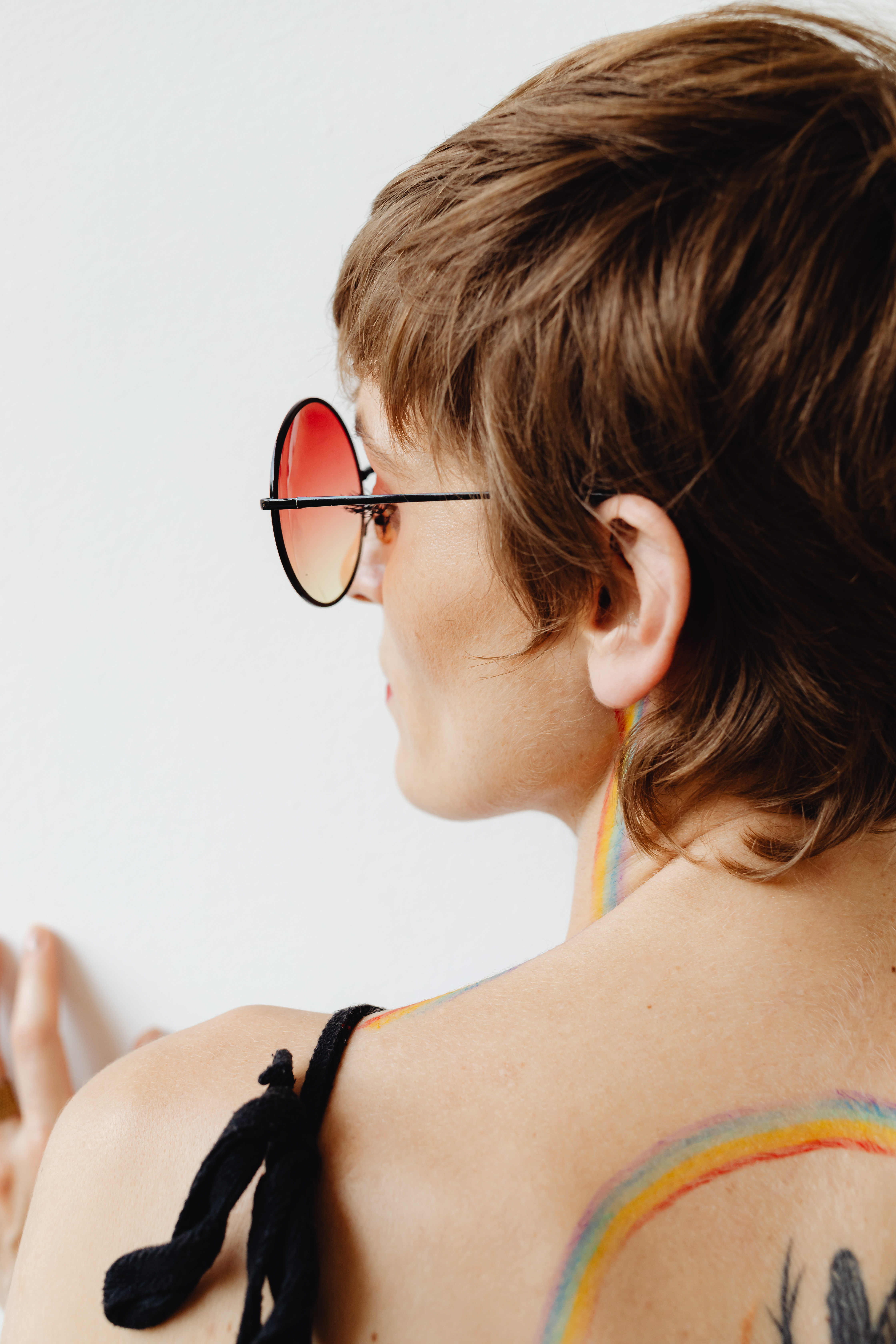 Girls paint an LGBT rainbow on their bodies