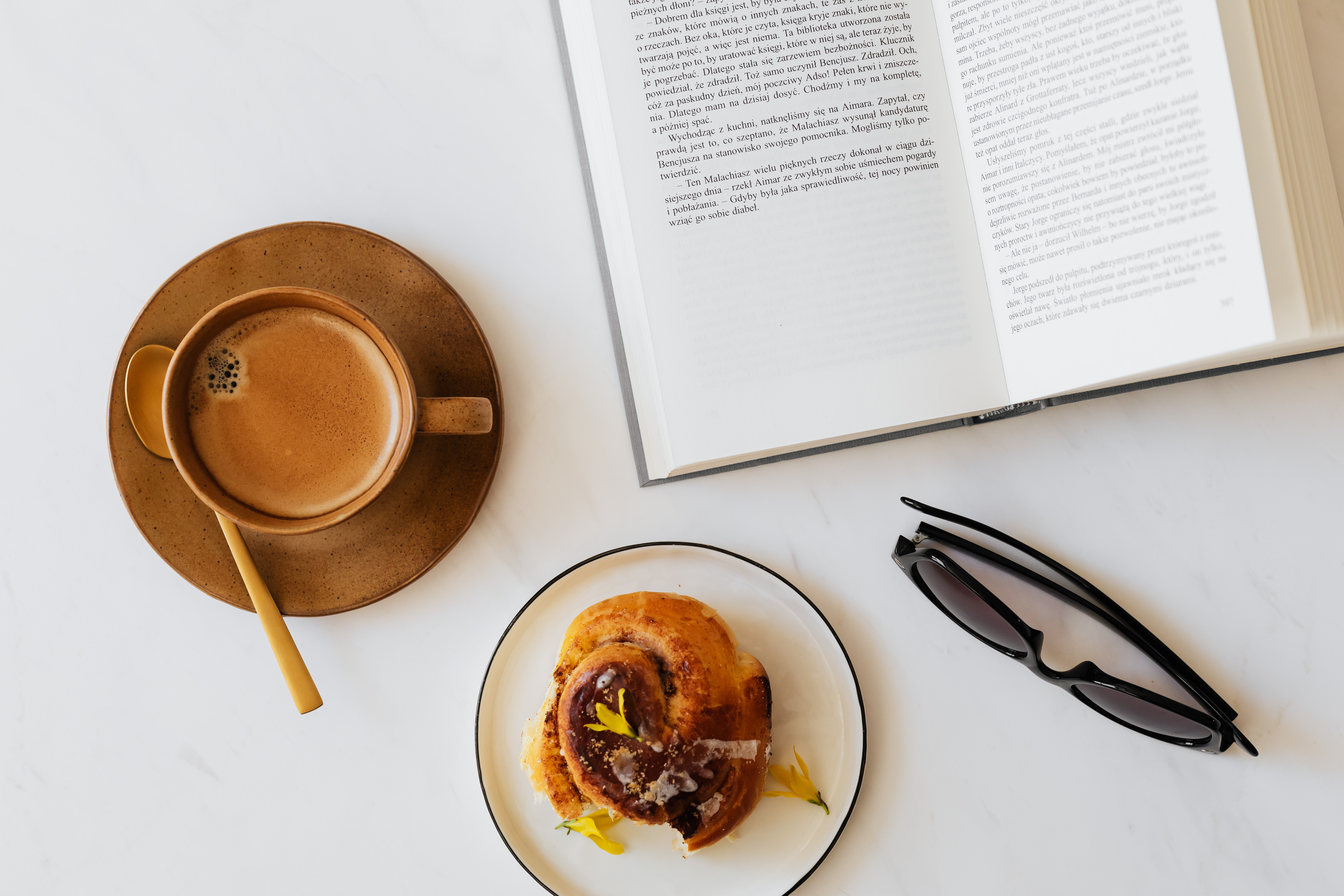 Coffee - book - cinnamon roll - sunglasses