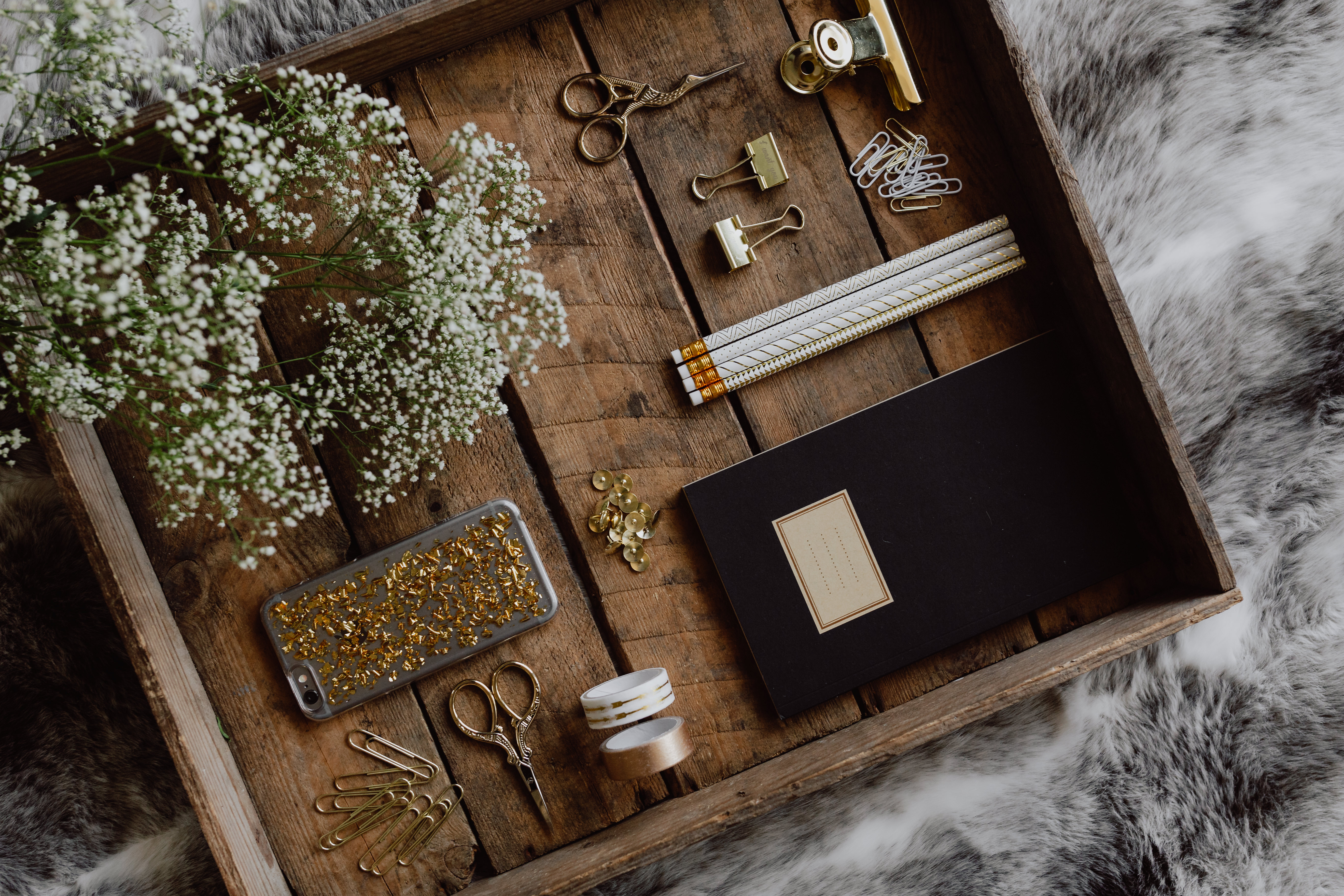 Office accessories on an old wooden tray