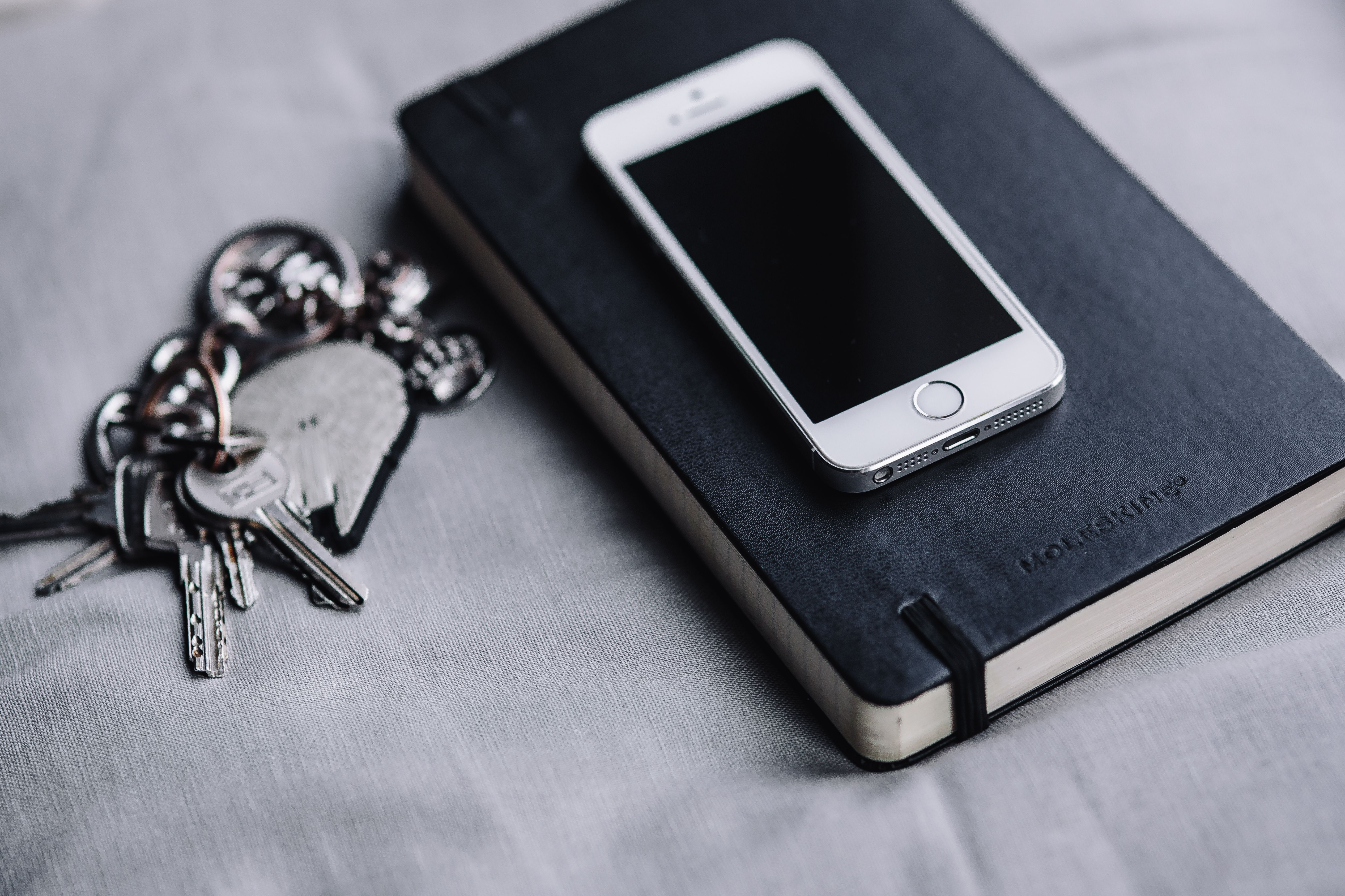 iPhone, Moleskin notebook, keys