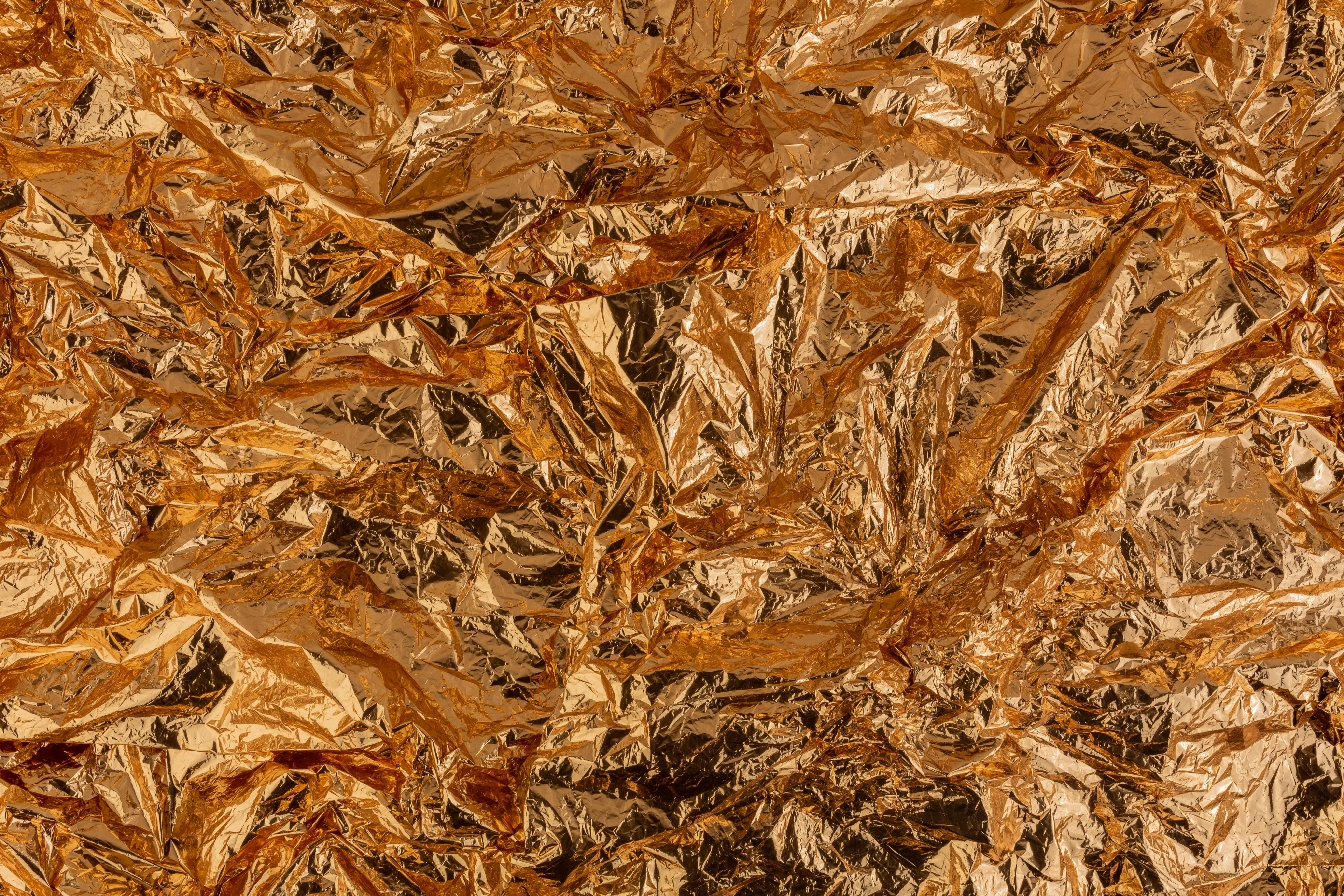 Gold crumpled aluminum foil texture