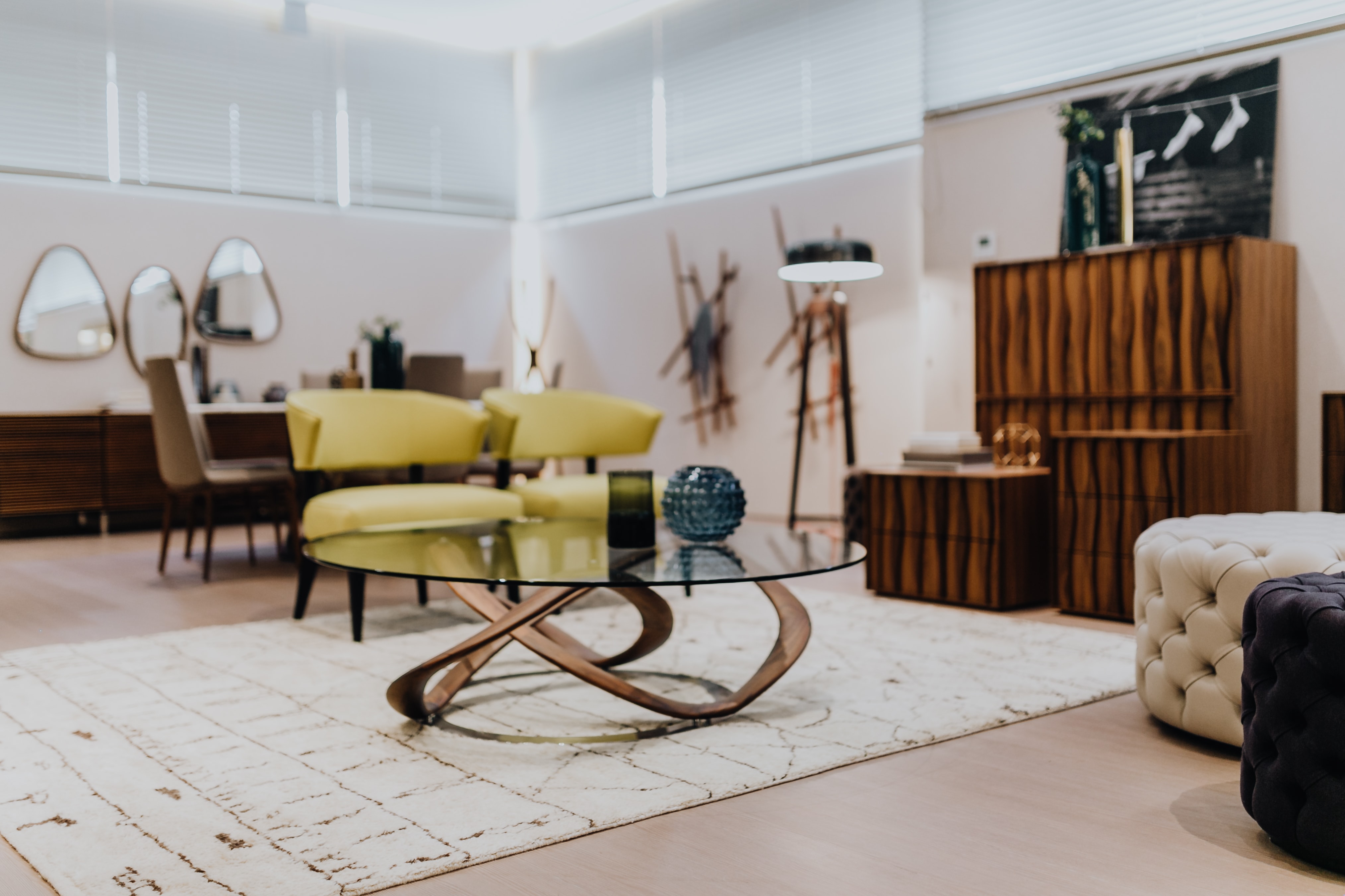 Luxury livingroom interior with table, chairs, commode, poufs, rug