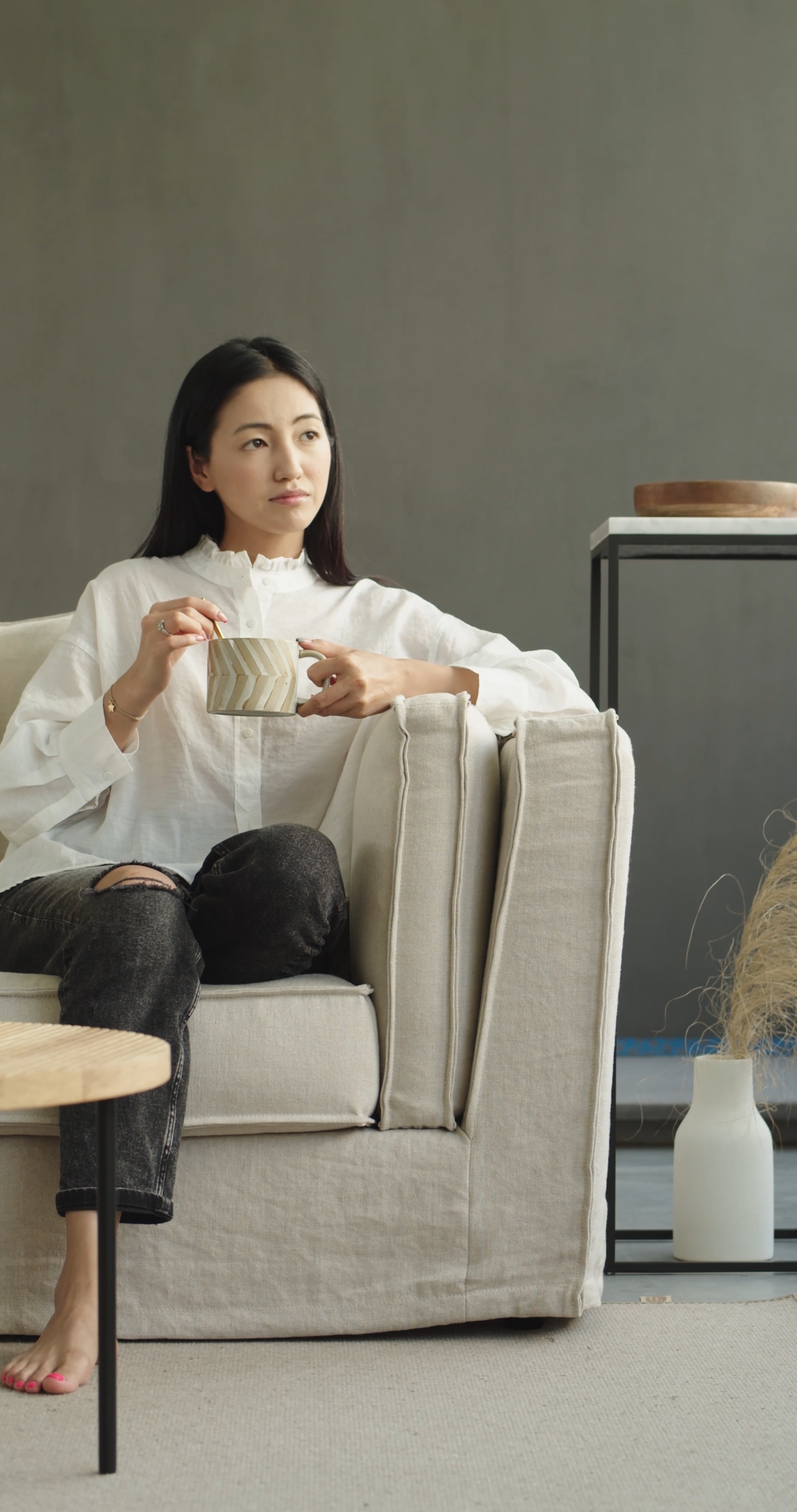 Woman on a Couch Enjoying a Cup of Coffee