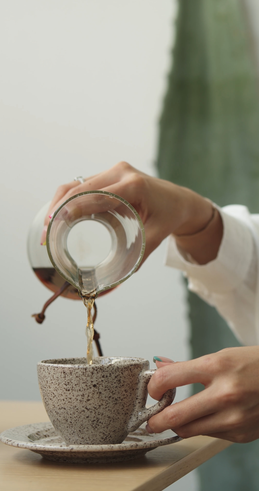 Close-up on a Woman Making a Cup of Coffee, Slowly Pouring Coffee into a Cup