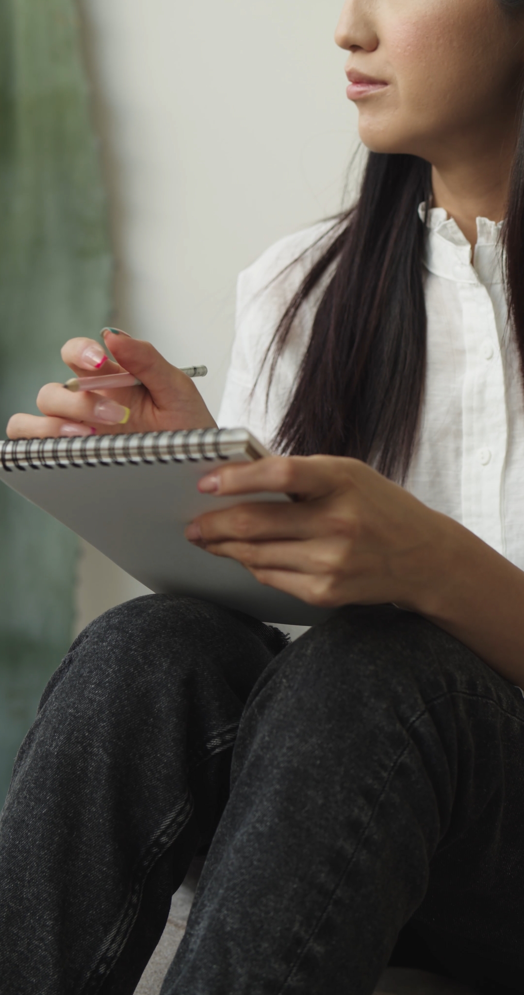 Woman Taking Notes in a Notebook