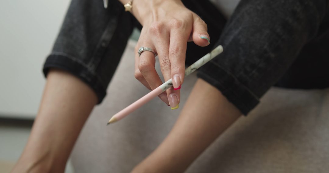 Close Up on a Woman Holding a Pencil, Playing with Pencil