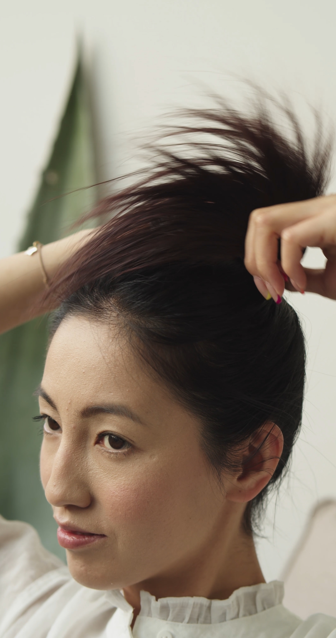 Woman Tying Hair in a Bun