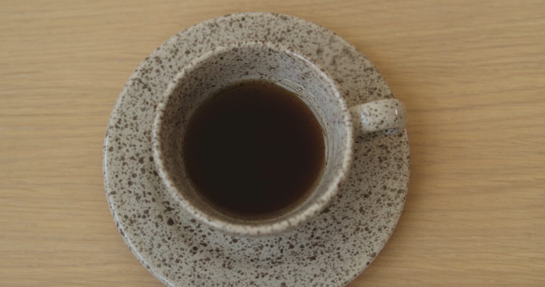 Putting a Cup of Coffee on the Table Close-Up