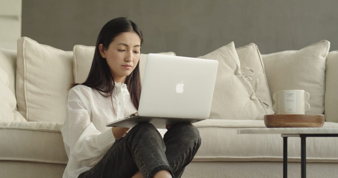 Woman Thinking While Working on Her Laptop