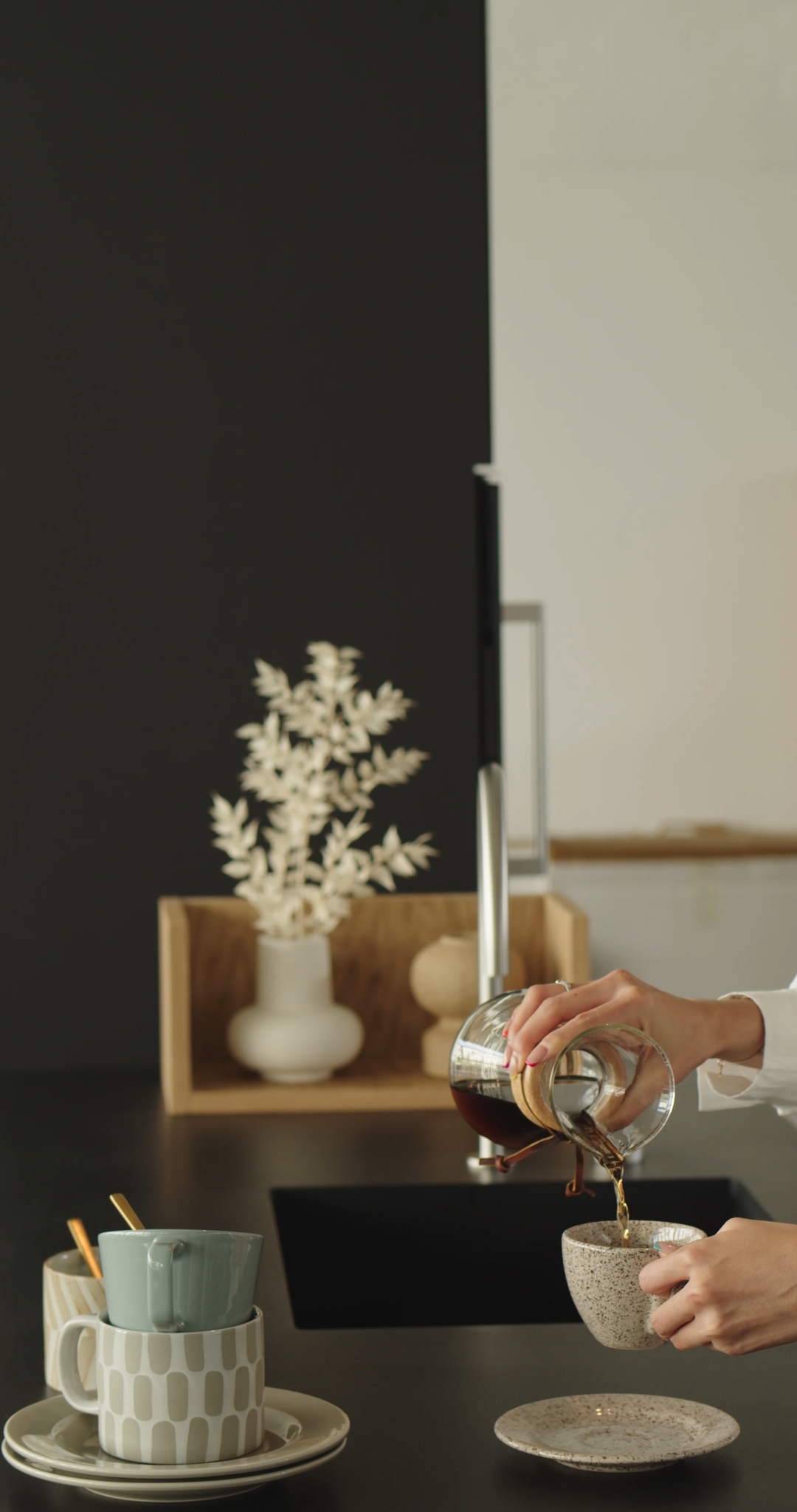 Woman Slowly Pouring Coffee into a Cup