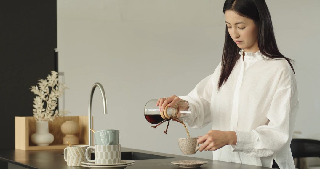 Woman in the Kitchen Making Coffee