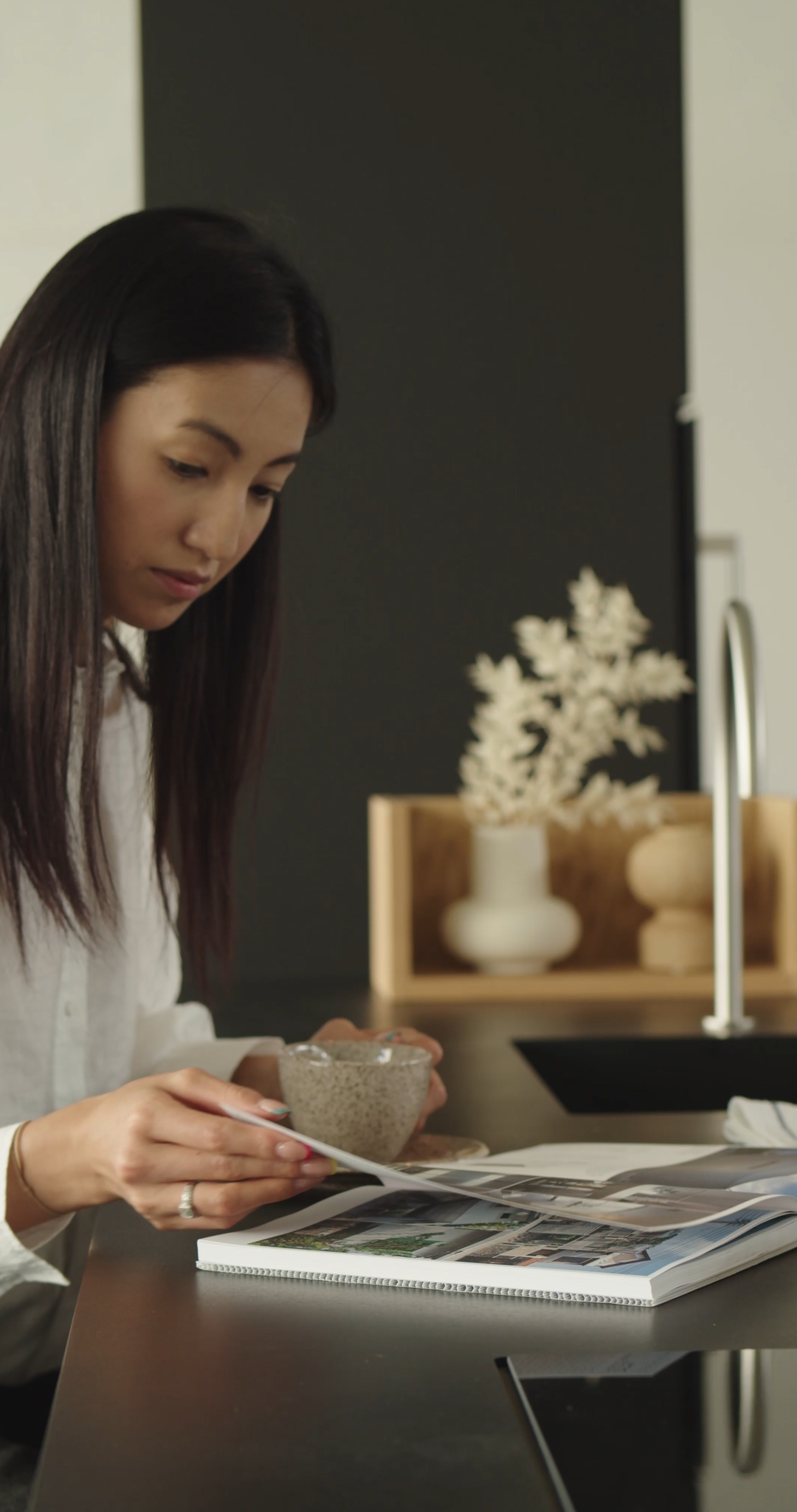 Woman Drinking Coffee and Reading a Book