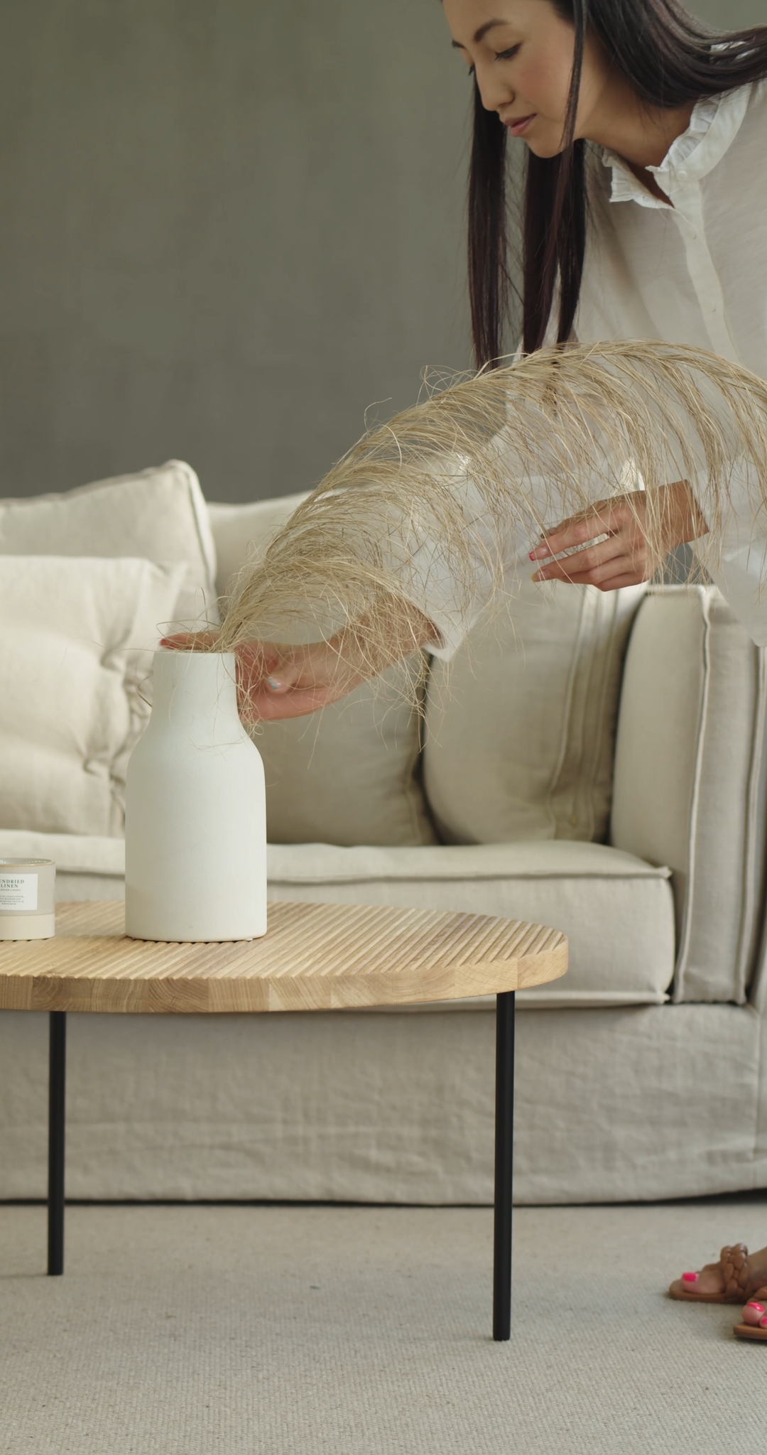 Woman With Pink Pedicure Placing Decorative Vase on the Table