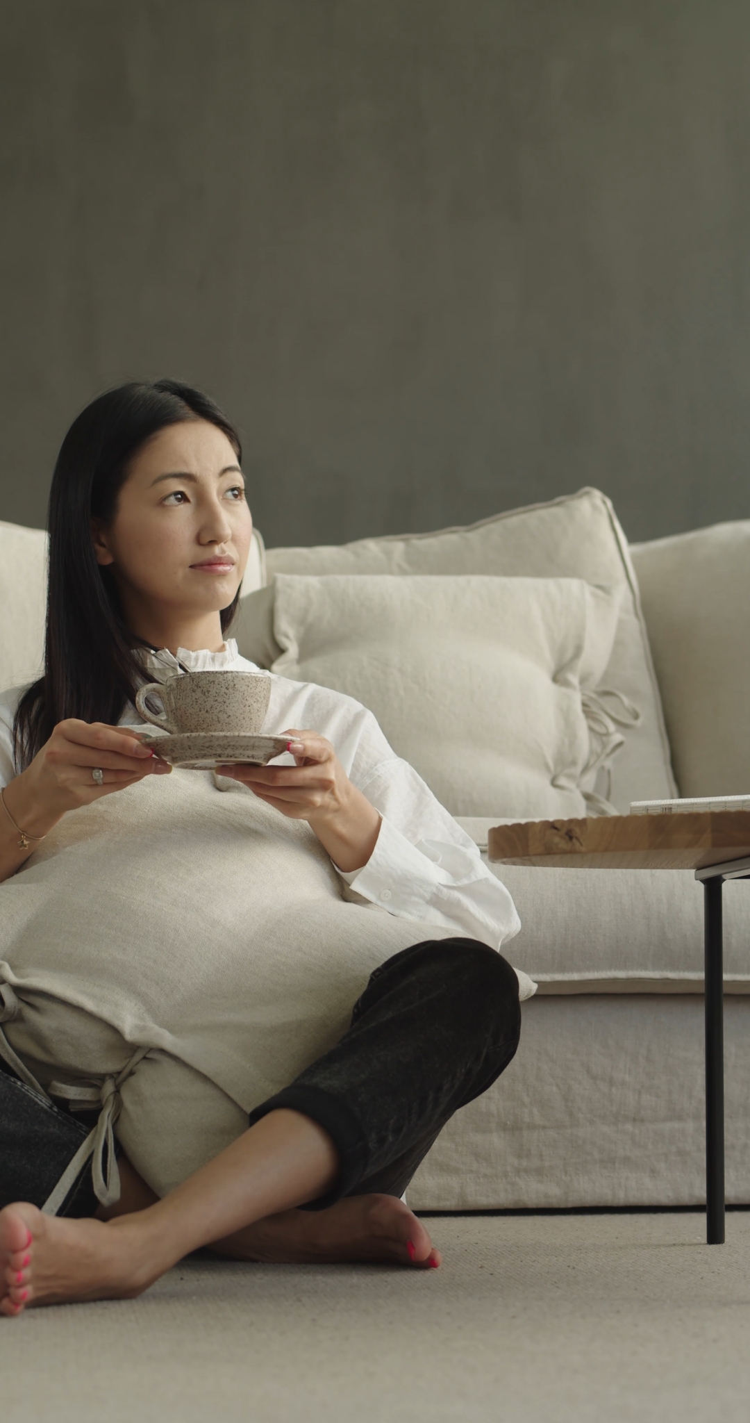 Woman Taking a Cup of Tea From the Table